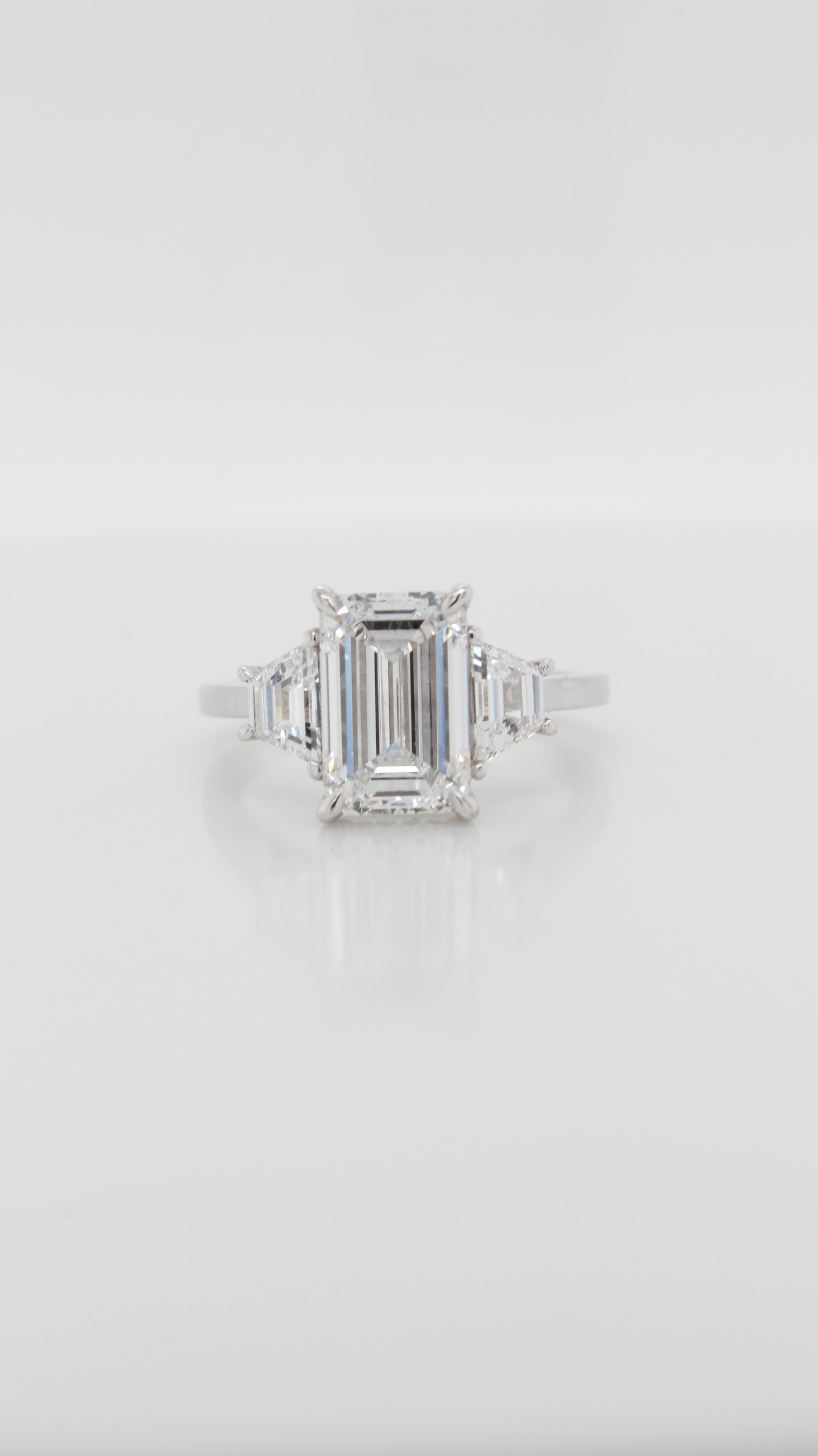 Emerald Cut Diamond with Trapezoid Sides in the Trilogy Design with Hidden Halo